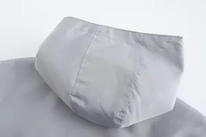Detailed view of grey breathable hooded jacket showing high-quality fabric and stitching