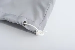 Close-up detail of breathable grey sport jacket with adjustable white drawstring toggle