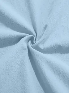 Detailed close-up of light blue cotton linen fabric texture for men's casual shirt