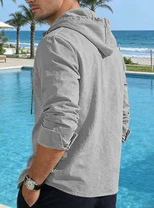 Macro view of a grey cotton linen hooded long sleeve shirt for men at a seaside pool