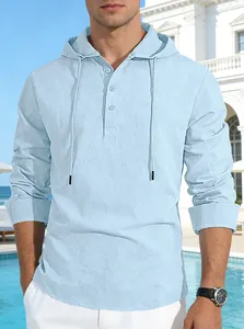 Detail shot of light blue cotton linen hooded shirt on a male model outdoors