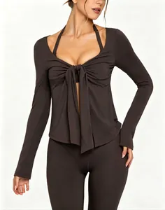 Detail view of a charcoal long-sleeve yoga top featuring a stylish tie-front V-neck design