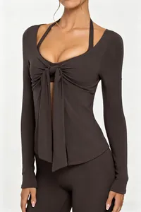 Close-up view of dark brown yoga top featuring a stylish front tie design and V-neck detail