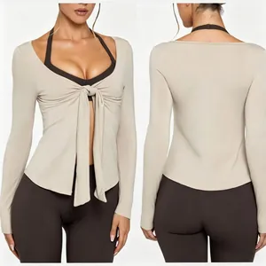 Front and back view of a long-sleeved yoga jacket with tie-front detail and V-neckline