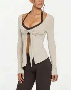 Detailed view of a beige V-neck long-sleeve yoga top featuring a stylish tie-front design