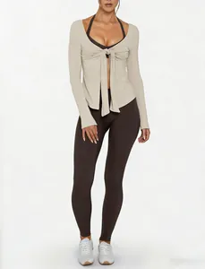 Detail view of tie-front long-sleeved yoga jacket with sports bra and leggings set