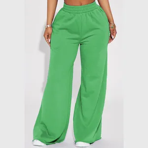 Close-up detail of women's casual green wide-leg trousers with elastic waistband