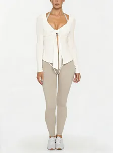 Close-up of white V-neck yoga top featuring a front tie knot design and long sleeves