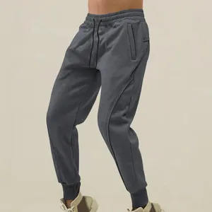 Men's charcoal grey athletic joggers with drawstring waist and cuffed ankles for fitness
