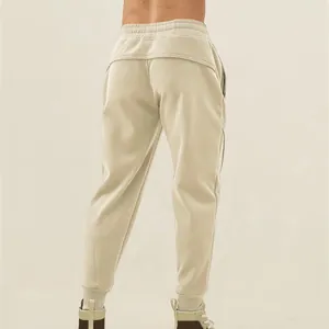 Men's loose fit American style athletic sweatpants with tapered cuffs in beige cream color