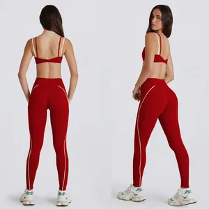 Conjunto de yoga rojo de dos piezas con ribetes blancos, sujetador deportivo y leggings altos.