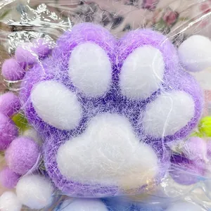 Close-up of a soft purple flocked cat paw squishy toy showing its unique fuzzy texture