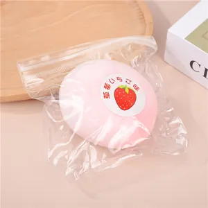 Soft pink strawberry daifuku mochi squishy toy presented in a clear plastic zipper bag