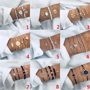 Collection of nine Bohemian bracelet sets featuring world map and heart charms on wrist