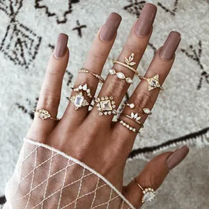 Close-up detail of bohemian style gold ring set with sparkling crystals on a model's hand