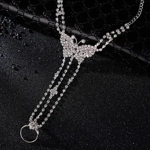 Elegant silver-tone hand chain featuring a delicate rhinestone butterfly pendant detail