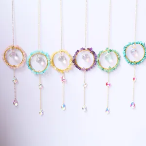 Close-up detail of six colorful crystal suncatchers with various gemstone-wrapped gold hoops