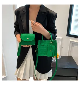 Detail shot of green felt handbag set with crocodile pattern and sub-mother bags
