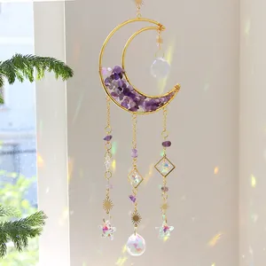 Close-up of handmade crescent moon suncatcher with amethyst stones and crystal prisms