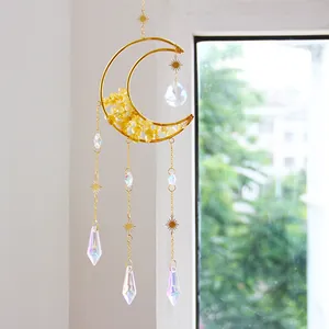 Close-up of handmade crystal suncatcher with moon frame and natural citrine stones