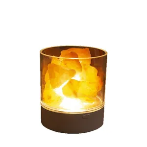 Natural mineral salt stone night light with warm glow in a transparent cylinder base.