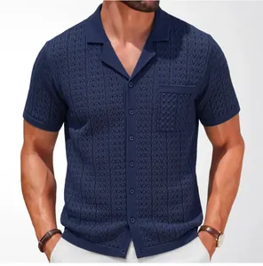 Close-up of navy knit polo shirt showing jacquard texture and Cuban collar detail.