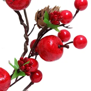 Vibrant artificial Christmas red berry branch with pine cone for festive holiday decoration