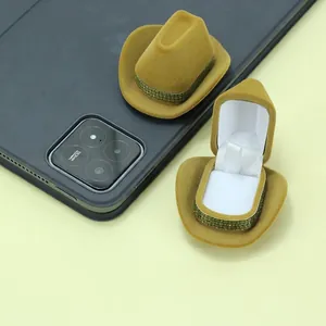 Close-up detail of mini suede cowboy hat jewelry boxes in open and closed views