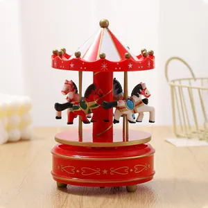 Detailed view of a classic red and white carousel music box with miniature horses