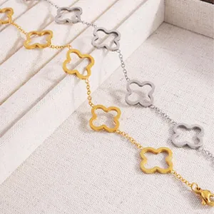 Detailed view of gold and silver-tone clover leaf bracelets on a display tray.