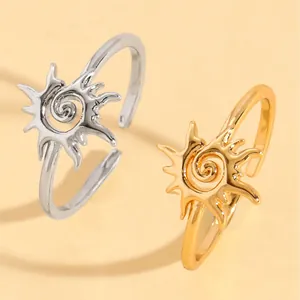 Detailed view of two vintage sun spiral rings in silver and gold ethnic finishes