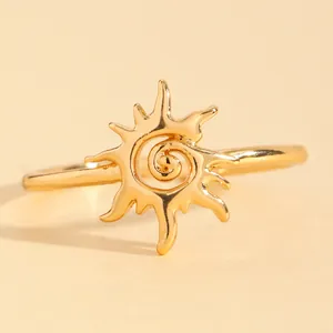 Detailed close-up of a vintage sunburst gold ring with spiral swirl design