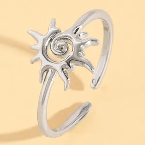 Close-up of a vintage silver sun swirl adjustable ring with detailed engraving