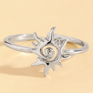 Detailed close-up of a vintage silver sun swirl ring with a spiral sunburst design.