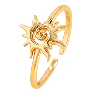 Macro detail of a vintage gold sun swirl adjustable open ring for women with ethnic style