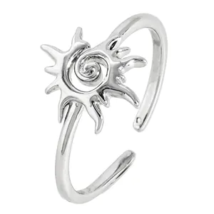 Close-up detail of a vintage silver sun-shaped ring with a central spiral vortex design