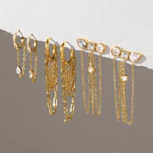 Close-up of gold-plated stainless steel earrings with zircon and chain tassels