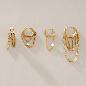 Detailed view of four gold-plated stainless steel hoop earrings with zircon tassels.