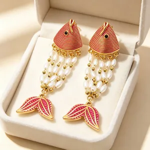 Exotic red fish enamel earrings with pearl tassels in a beige velvet jewelry box