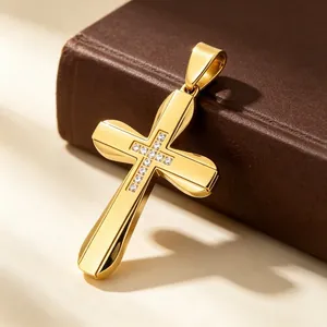 Close-up of a gold hip hop cross pendant with embedded crystals in titanium steel