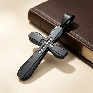 Detailed close-up of a matte black hip-hop cross pendant with inlaid rhinestones