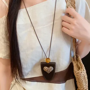 Nahaufnahme der braunen Herzkette aus Leder mit integriertem Brillenhalter-Clip.