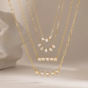 Detailed macro view of four 18k gold stainless steel zircon necklaces with geometric pendants
