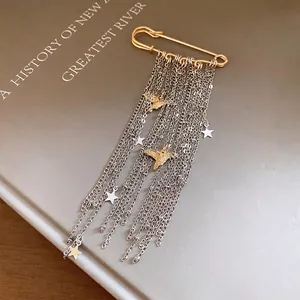 Elegant gold safety pin brooch with cascading silver chains, star and dove charms.