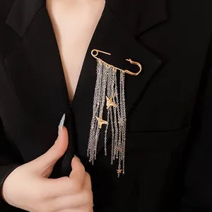 Detailed view of a star and peace dove tassel chain brooch pinned on a black blazer