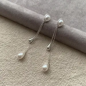 Elegant teardrop tassel pearl earrings in silver finish for a minimalist chic look.