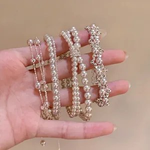 Elegant set of French vintage faux pearl bracelets with shimmering rhinestone accents