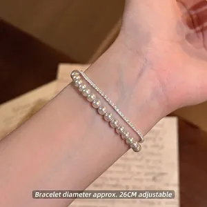 Close-up of elegant pearl and rhinestone bracelet with adjustable pull-type design