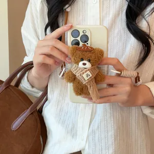 Close-up of a cute brown plush bear pendant charm with a stylish nylon rope strap.