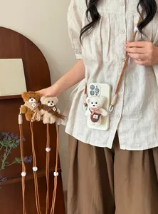 Plush bear phone strap with double nylon ropes, shown on model in various colors.
